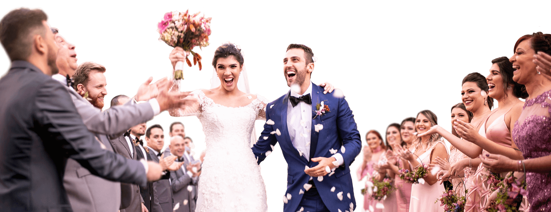 Image of wedding party throwing flower pedals at newly weds