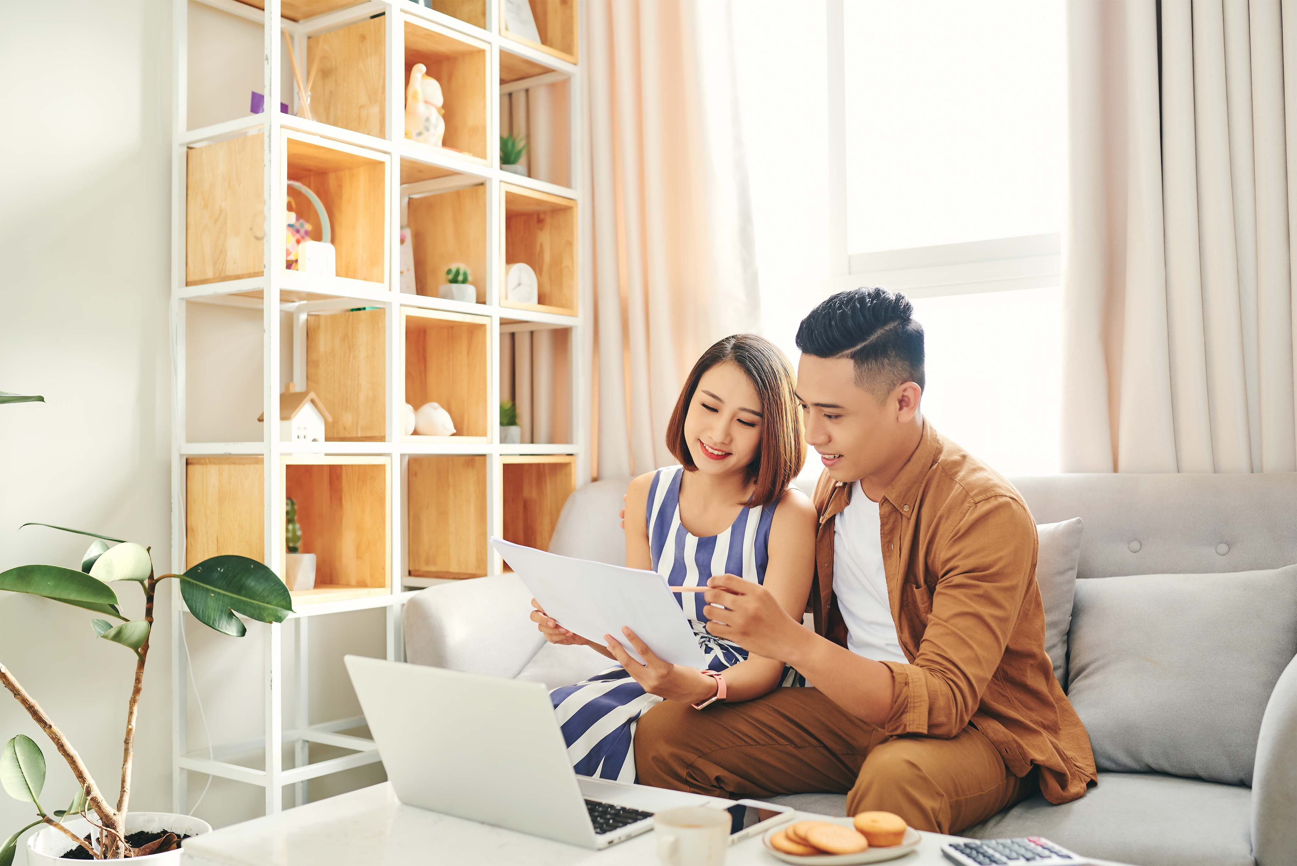 couple looking at their computer and paper work