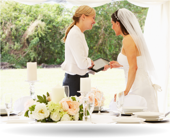 two women at a wedding reviewing a checklist on a tablet device